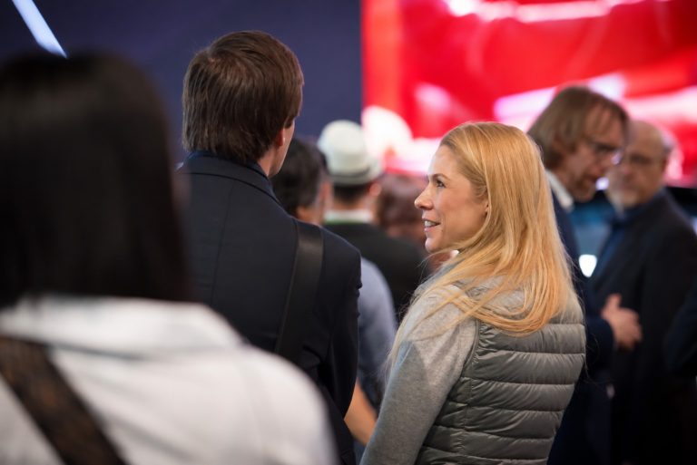 Candid conversation at a trade show photographed by Tim Rogers